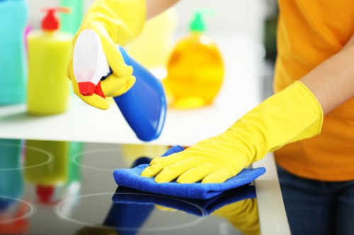 Office cleaning team sanitizing shared workspace surfaces